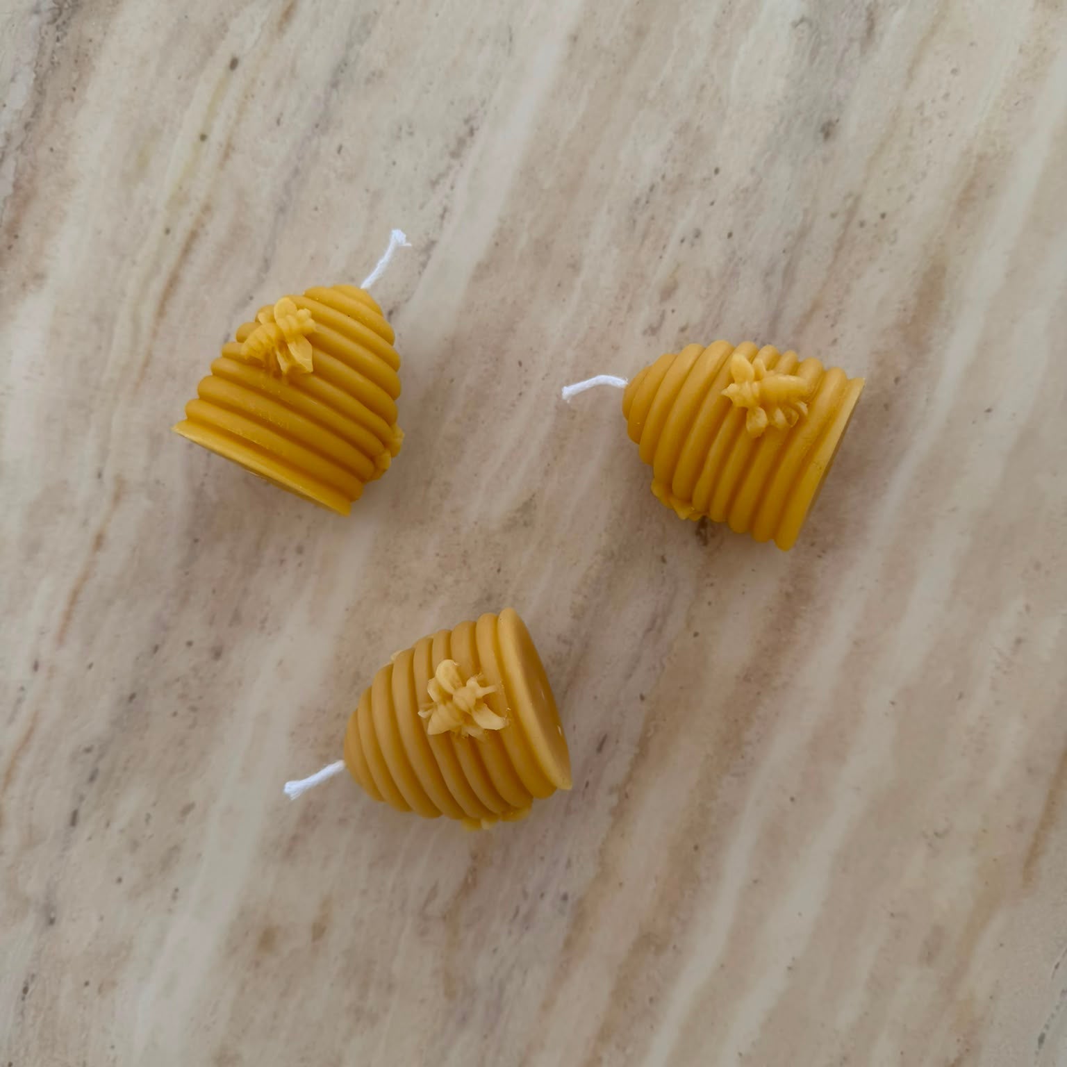 3 Beehive Shapes Beeswax Candles on Marble Surface