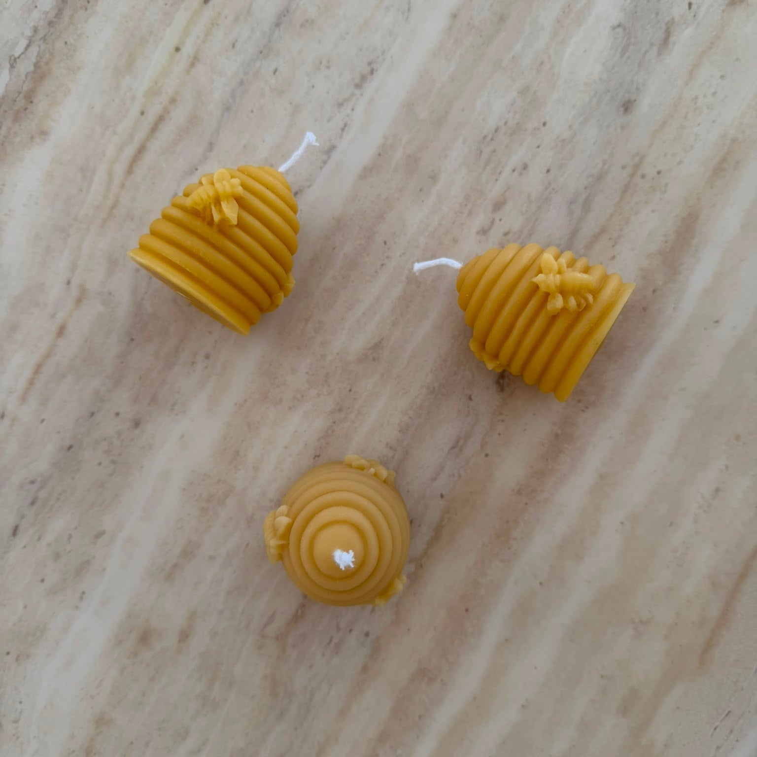 3 Beehive Shaped Beeswax Candles on Marble Surface